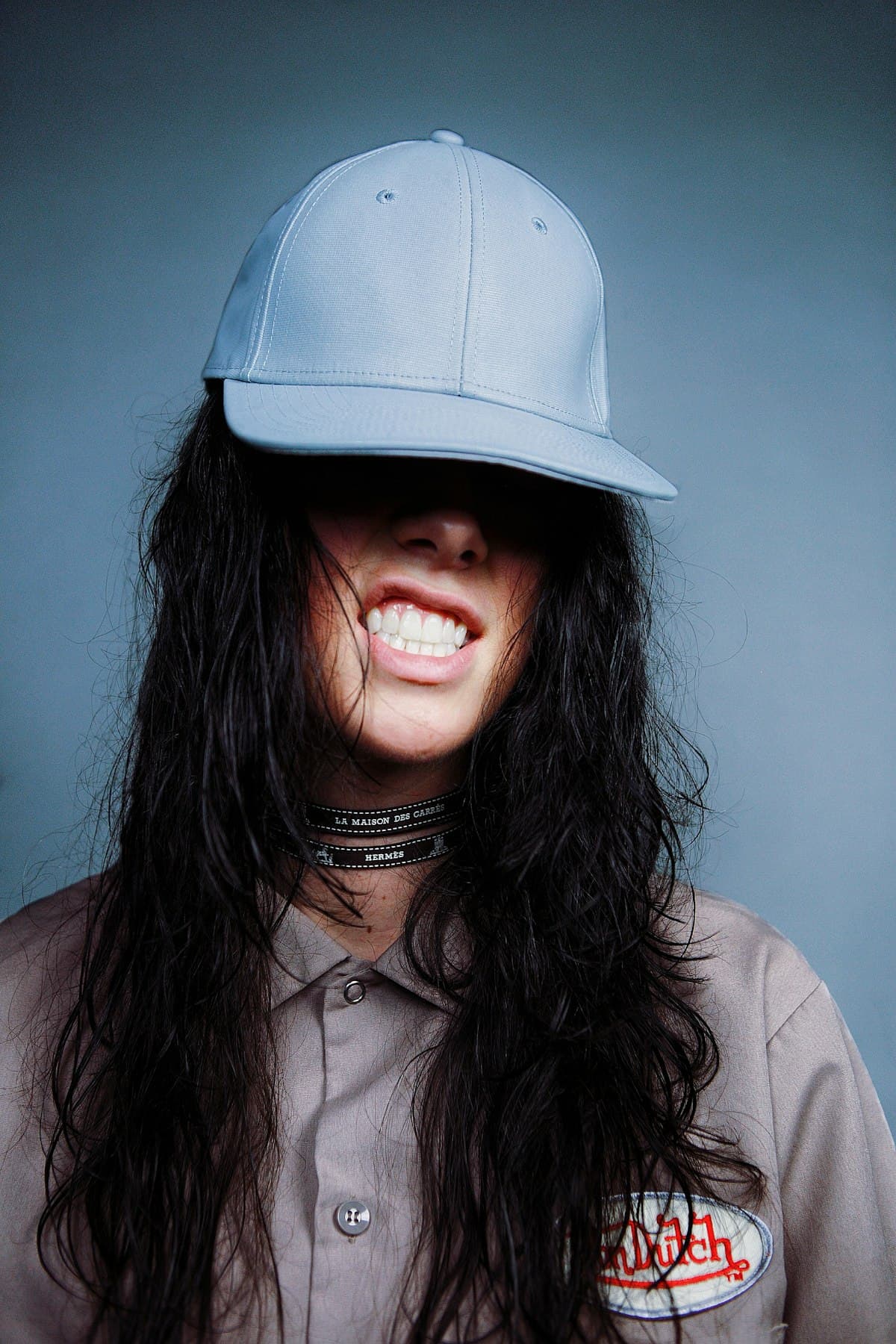 Sky blue snapback worn low