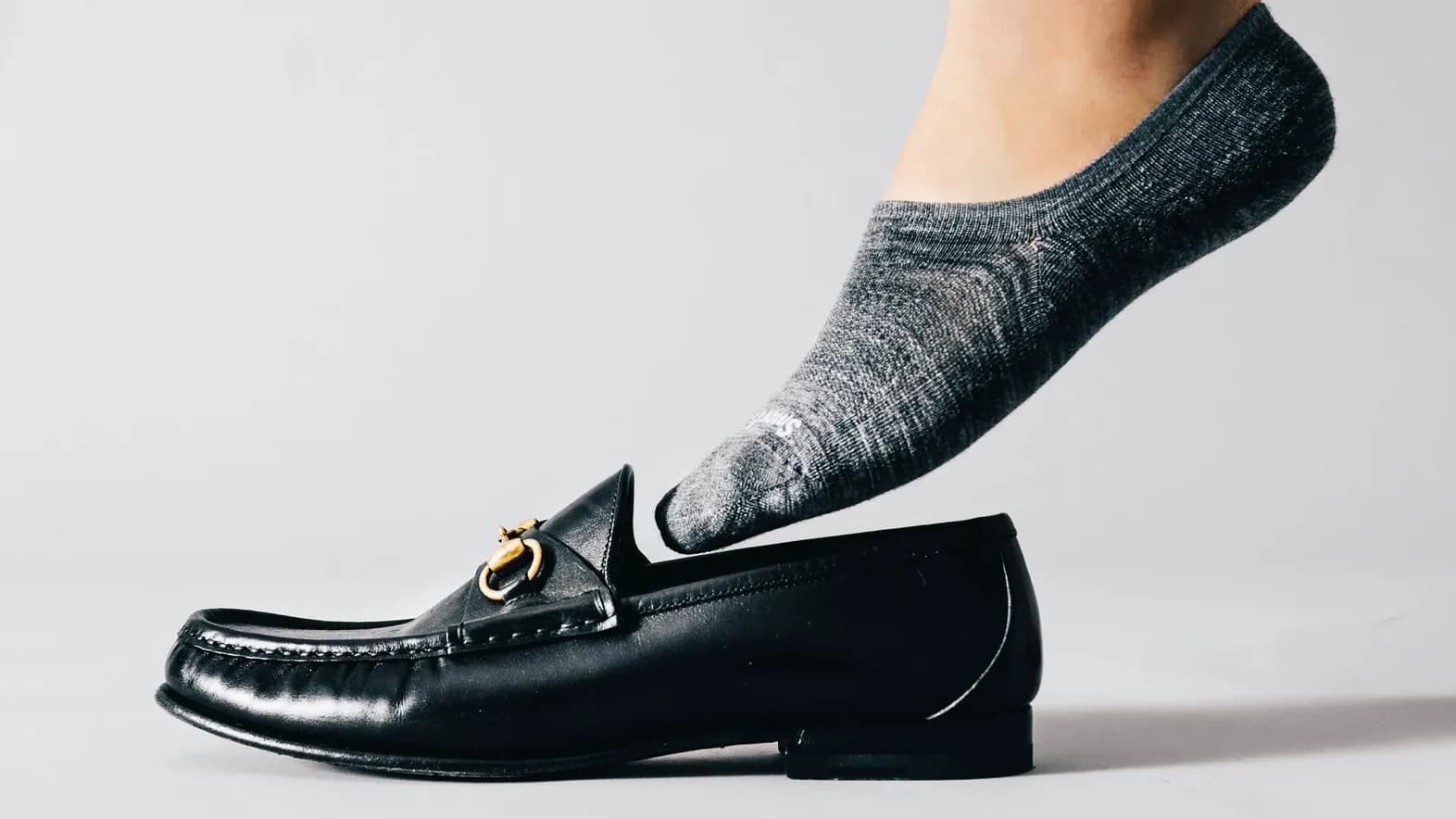 Charcoal no-show sock worn with a leather loafer